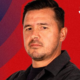 Portrait of a man in a black shirt against a red and blue backdrop with the Atlético San Luis logo in the top-right corner