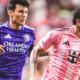 Two soccer players chase the ball on the field, one in a purple Orlando Health jersey and the other in a pink striped kit.