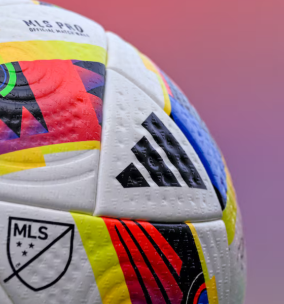 Close-up of a colorful MLS soccer ball with Adidas logo and textured panels.
