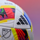 Close-up of a colorful MLS soccer ball with Adidas logo and textured panels.